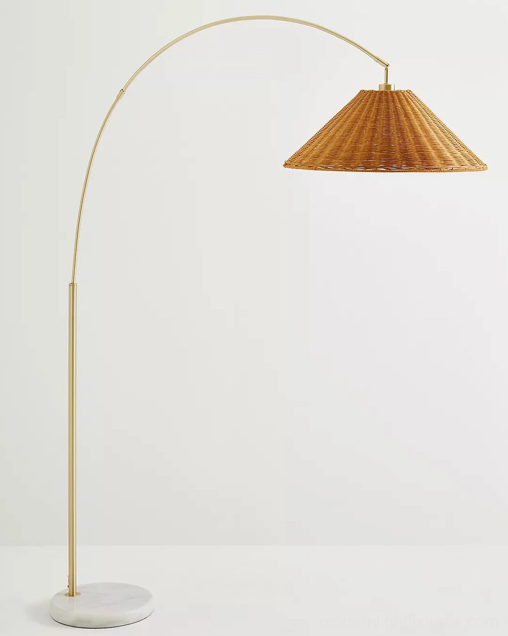 Madera arc floor lamp angled three-quarter view showcasing warm bohemian minimalist design and material composition