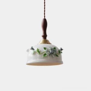 Maelis handcrafted ceramic pendant lamp with hand-painted blue floral details on white dome shade, front overhead studio view
