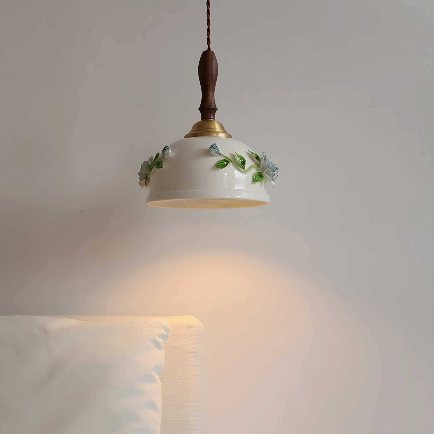 Maelis pendant lamp illuminated in cozy bedroom setting, casting warm golden light with soft glowing ceramic shade ambiance
