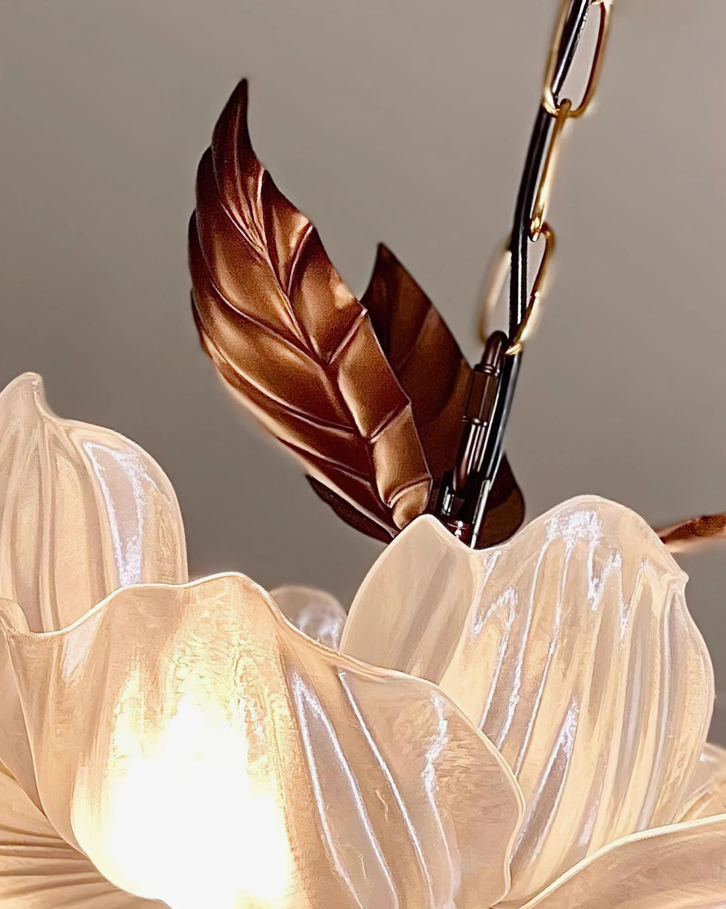 Magnolia Bloom chandelier artistic botanical design with sculpted bronze leaves and diffused petal lighting