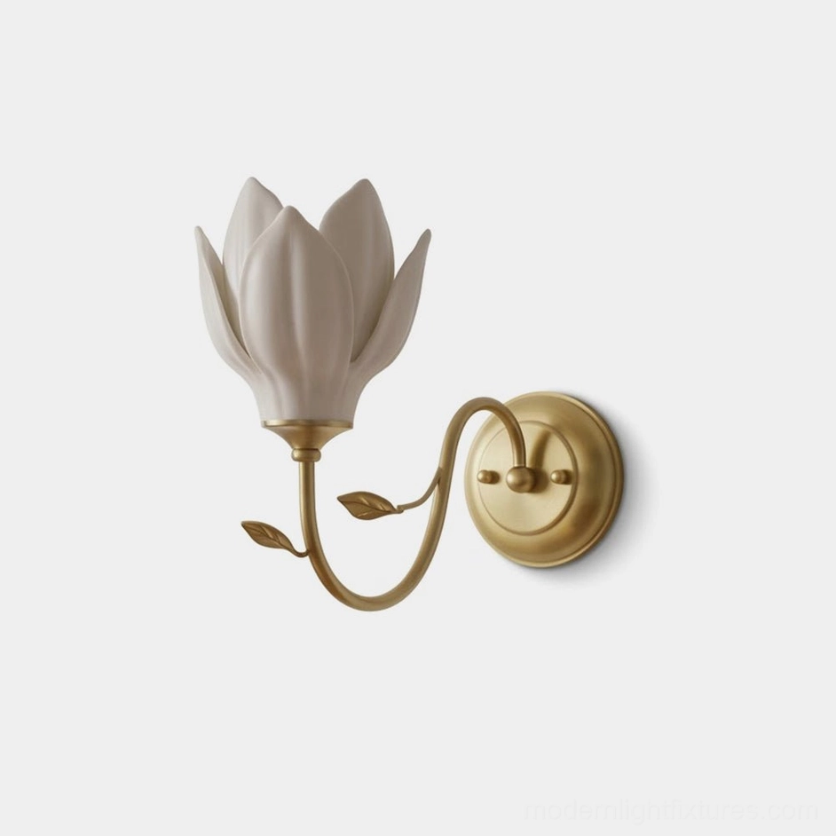 Magnolia bud ceramic wall sconce with white layered petals and brass curved arm, frontal studio view