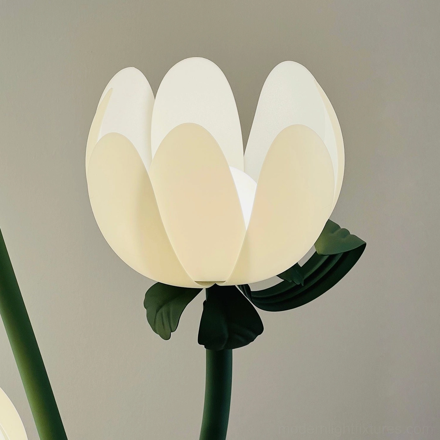 Magnolia floor lamp with white bloom acrylic shades and green metal stem providing layered ambient lighting solution