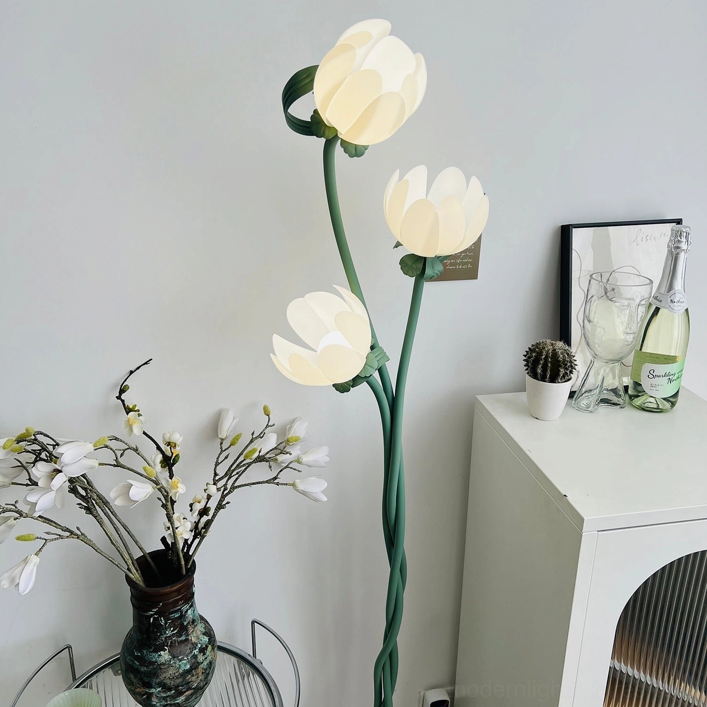 Close-up of magnolia floor lamp white acrylic bloom shade showing light diffusion and sculptural petal design