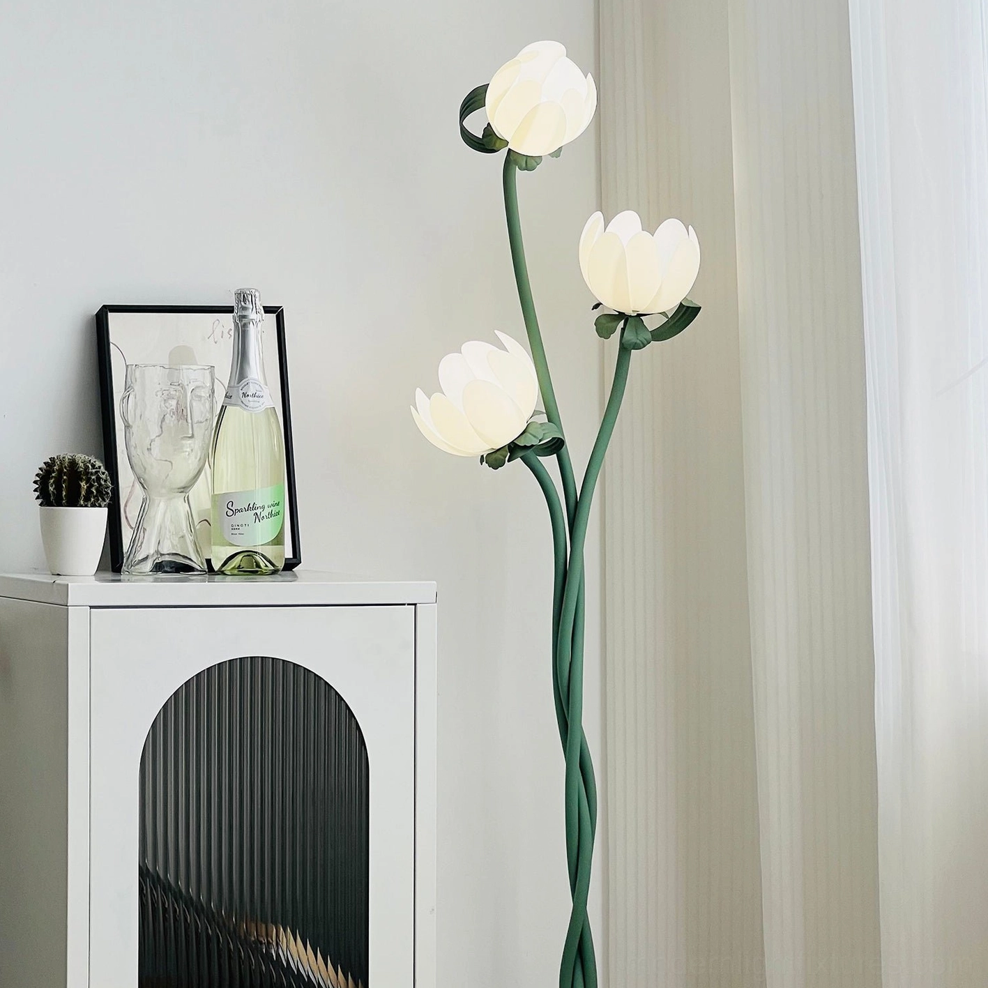 Magnolia bud floor lamp showing USB charging port at base and foot switch control mechanism on green metal stand