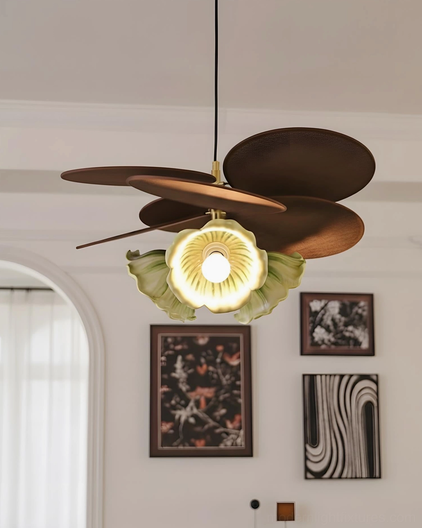 Magnolia sculptural pendant light with green accents mounted against minimalist bedroom accent wall