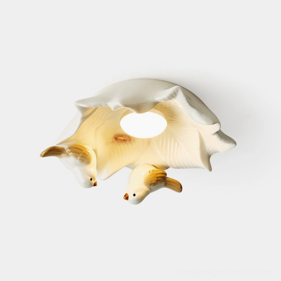 Magnolia Nest ceramic bird ceiling light fixture top-down view showing delicate bird sculptures and magnolia bloom design