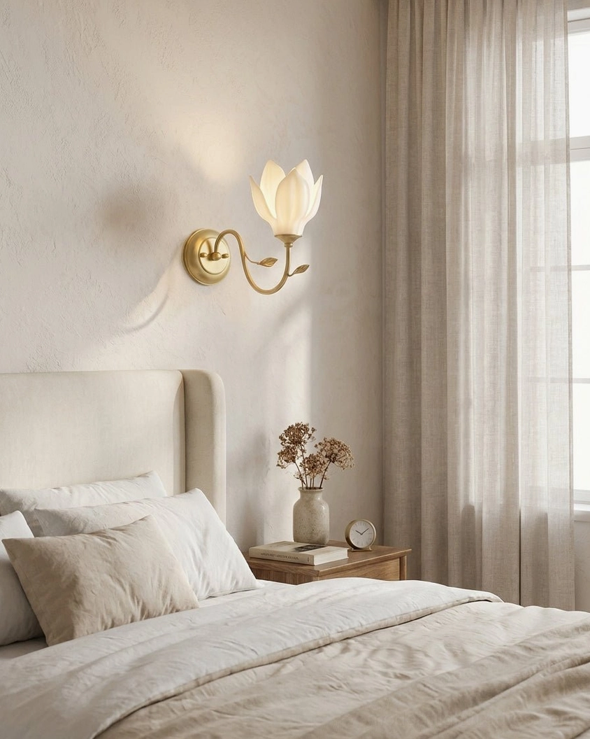 Magnolia wall sconce providing soft uplight in master bedroom beside nightstand with reading lamp
