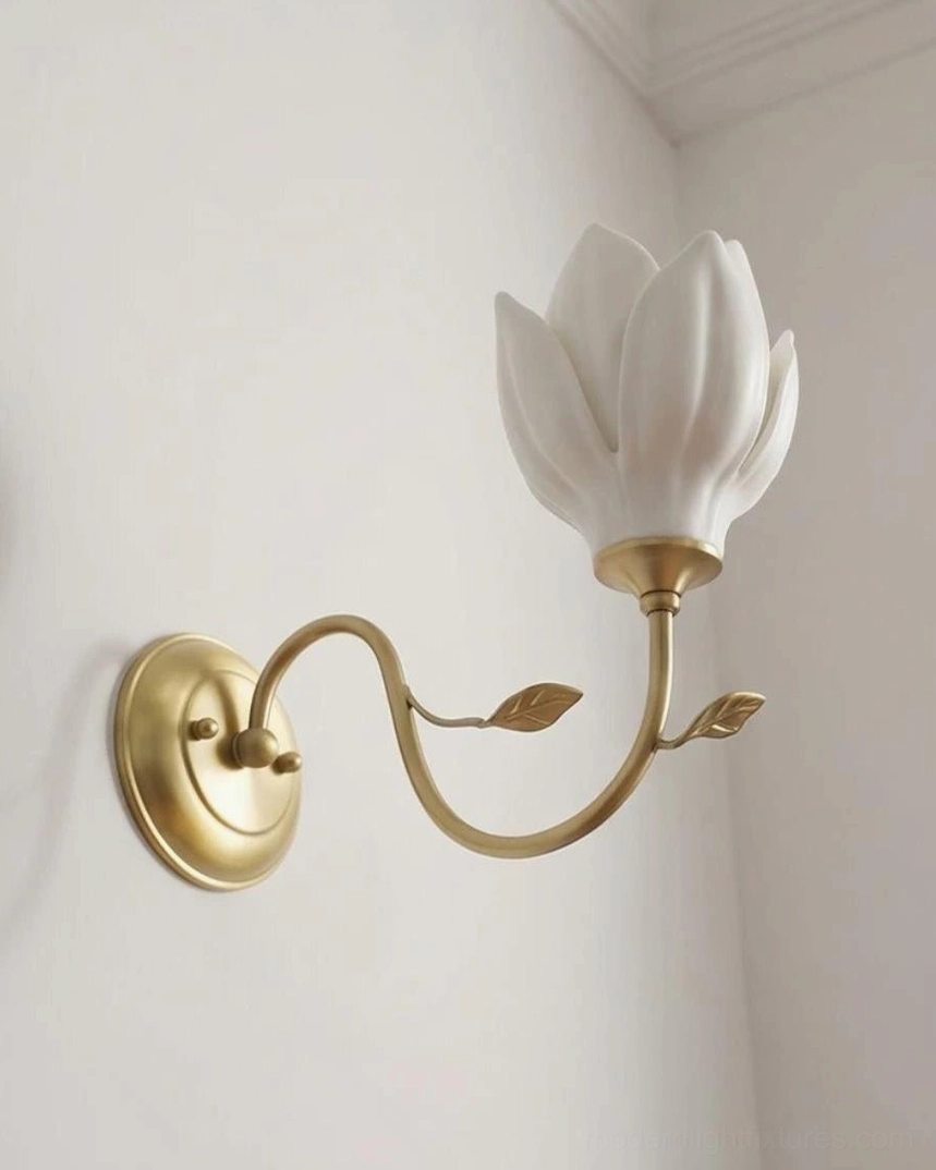Magnolia bud wall sconce close-up detail showing brass curved stem with decorative leaf elements