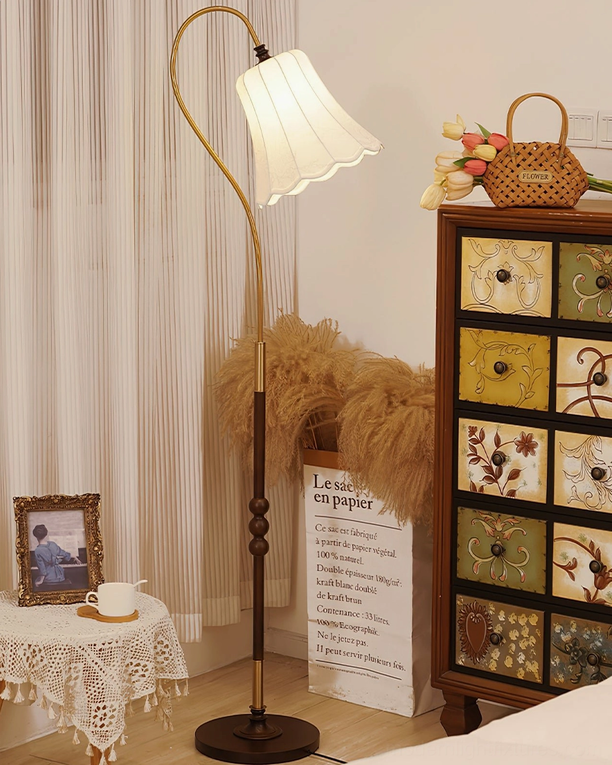 Magnolya arc floor lamp cozy bedroom corner, curved brass pole ruffled white fabric shade warm atmospheric lighting