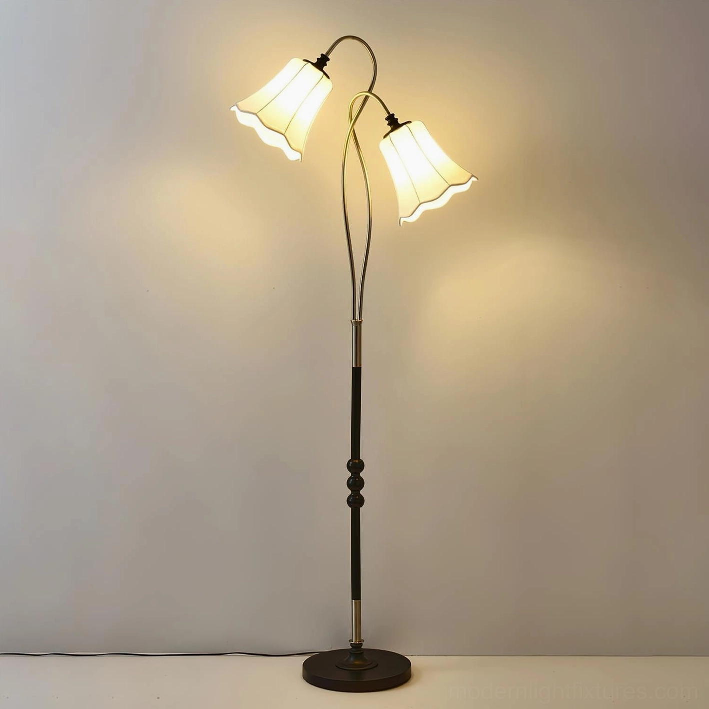 Magnolya vintage floor lamp front view light gray backdrop, dual-head dark metal pole illuminated warm light patterned shades