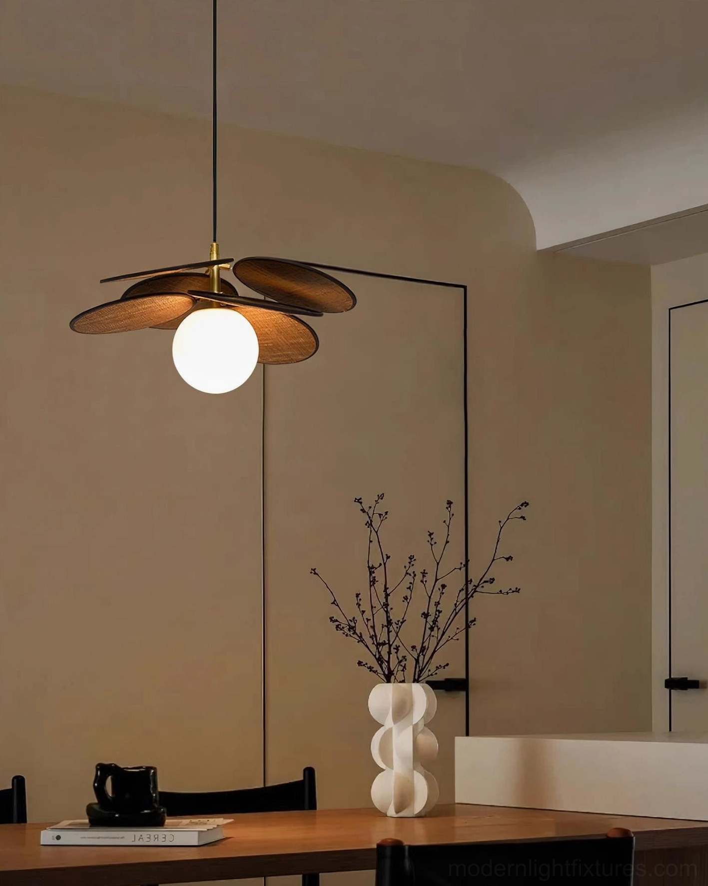 Compact Mahalo pendant lamp in minimalist dining area, small three-slat wooden design over dining table