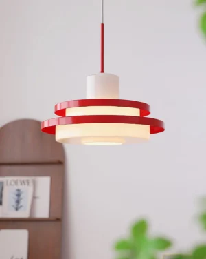 Maisie red and white pendant lamp hung in cozy living space with wooden decor and plants