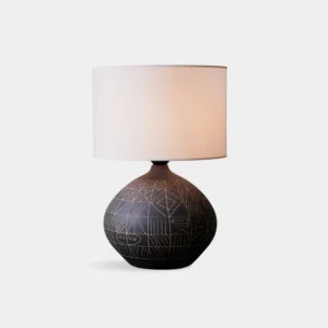Mako handcrafted ceramic table lamp with geometric sgraffito tribal pattern, front three-quarter view on white background