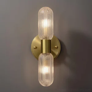 Double glass wall sconce Mallory illuminated bulbs close-up polished brass hardware