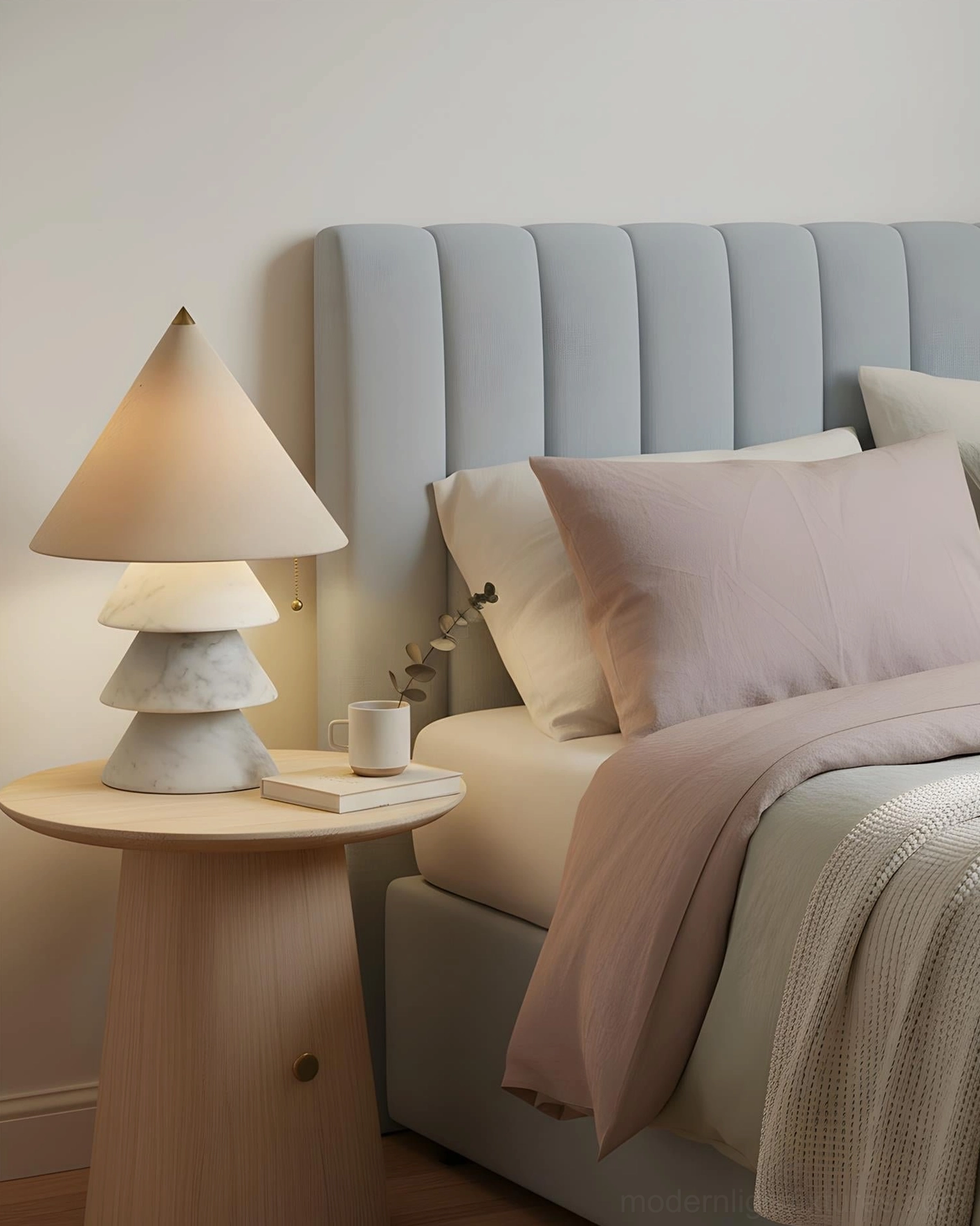 White tiered stone base table lamp with warm beige shade in modern neutral master bedroom