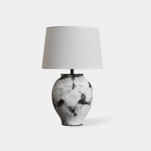 Malta hand-painted ceramic table lamp with abstract black and white brushstroke base and white tapered shade on white background