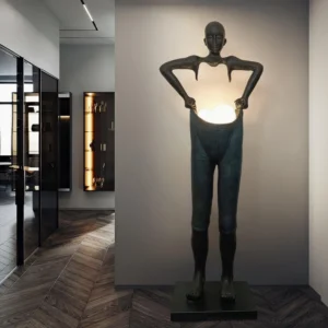 Modern sculptural floor lamp in contemporary hallway with herringbone wood flooring and minimalist design