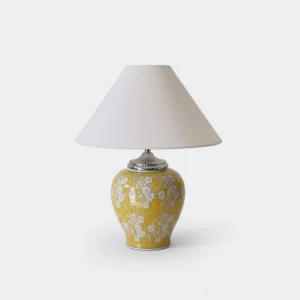 Hand-glazed yellow floral ceramic table lamp with white fabric shade and silver metal trim, front studio view showcasing classic ginger jar silhouette and intricate botanical motifs
