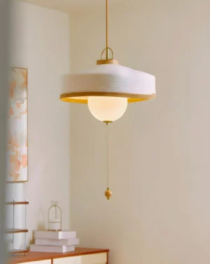 Mantle pendant light with gold pull chain in modern bedroom corner accent