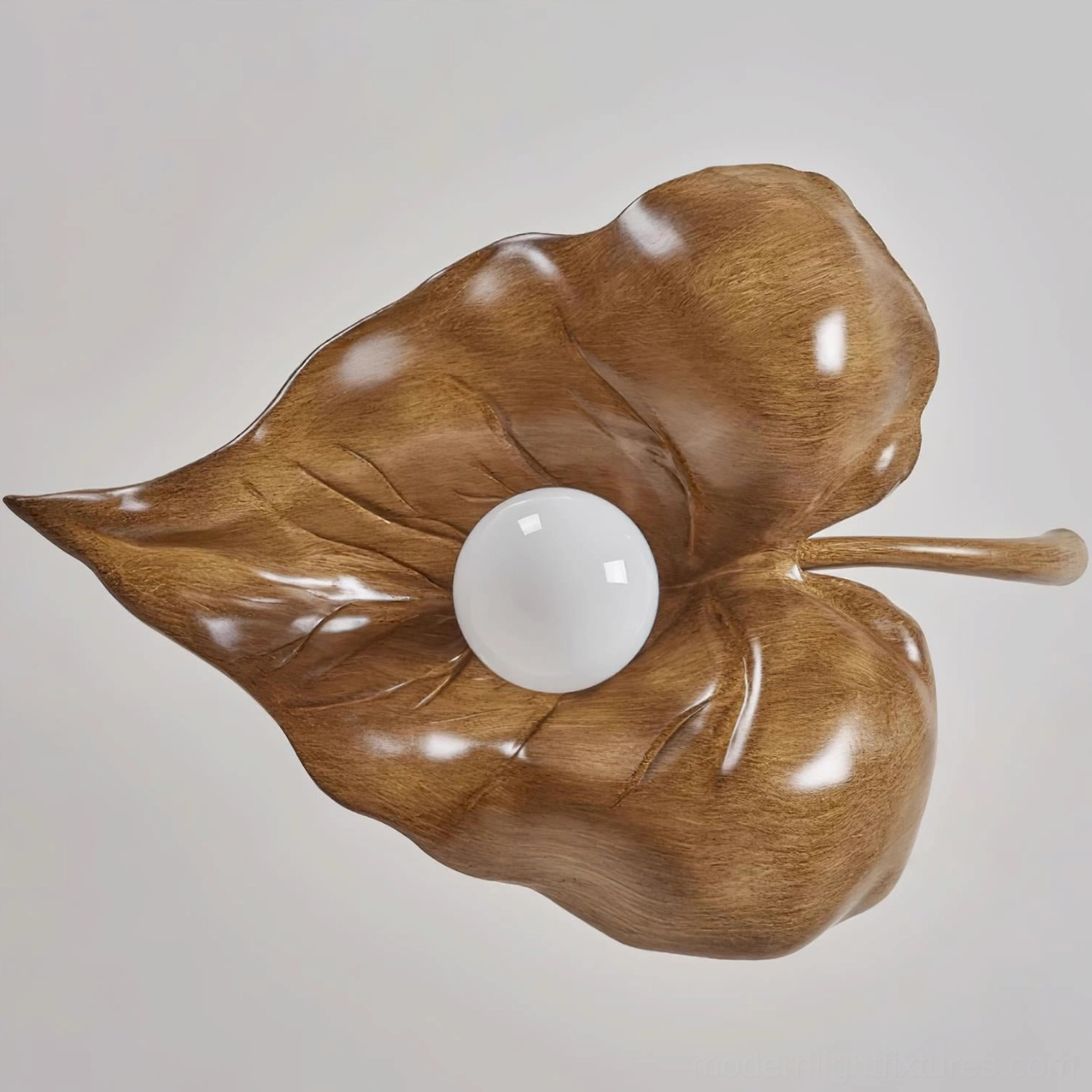 Close-up detailed view of maple leaf pendant lamp showing wood grain texture and central white bulb