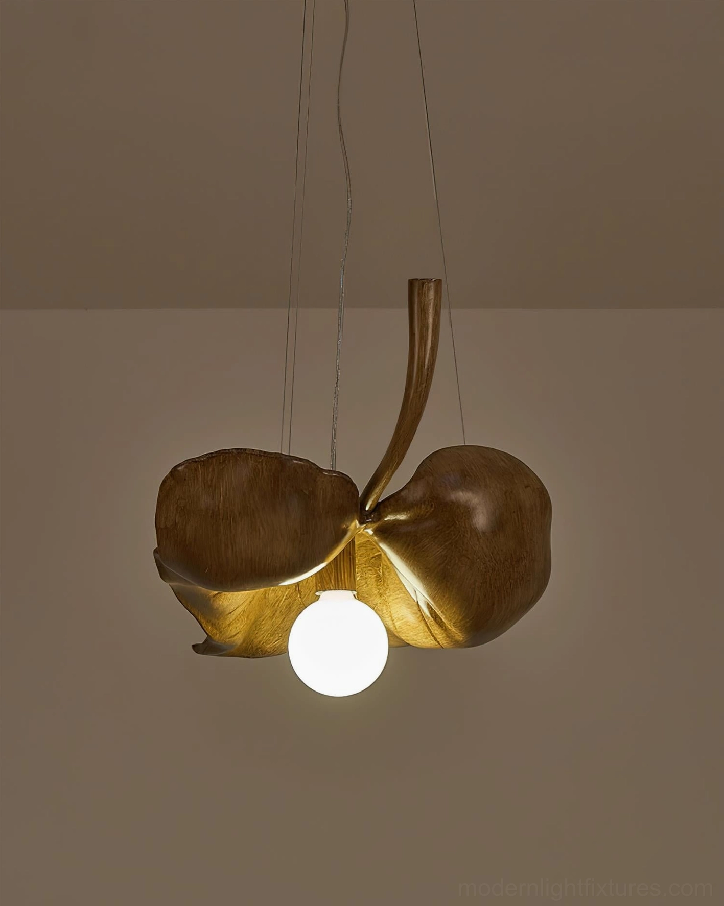 Maple leaf pendant light fixture hanging in modern residential space, contemporary interior design