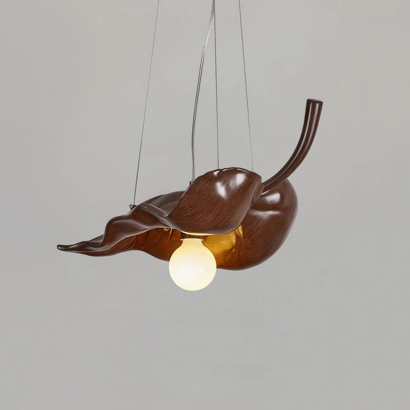 Brown resin maple leaf pendant light showing suspension cord details, front overhead studio shot