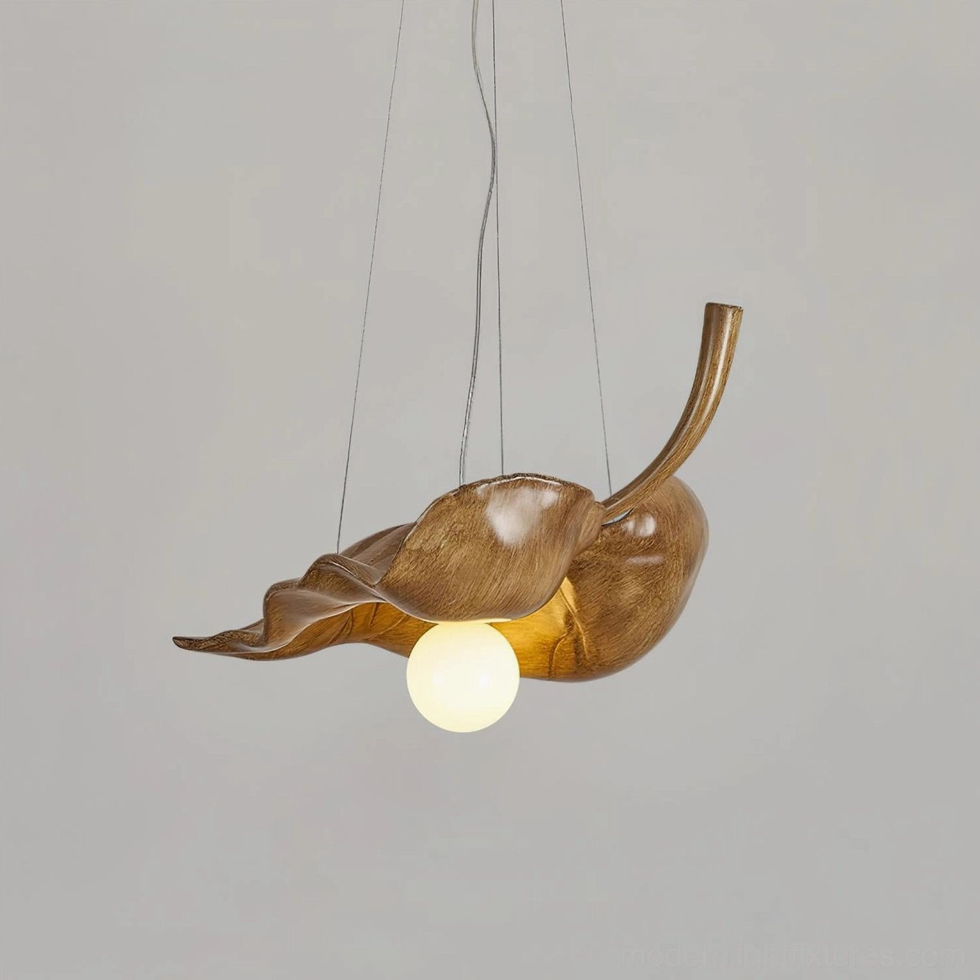 Side view of leaf-shaped resin pendant light showing suspension cords and natural wood grain texture