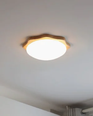 Natural maple wood ceiling light mounted overhead, low-angle eye-level view showing wavy wooden frame and round light panel detail