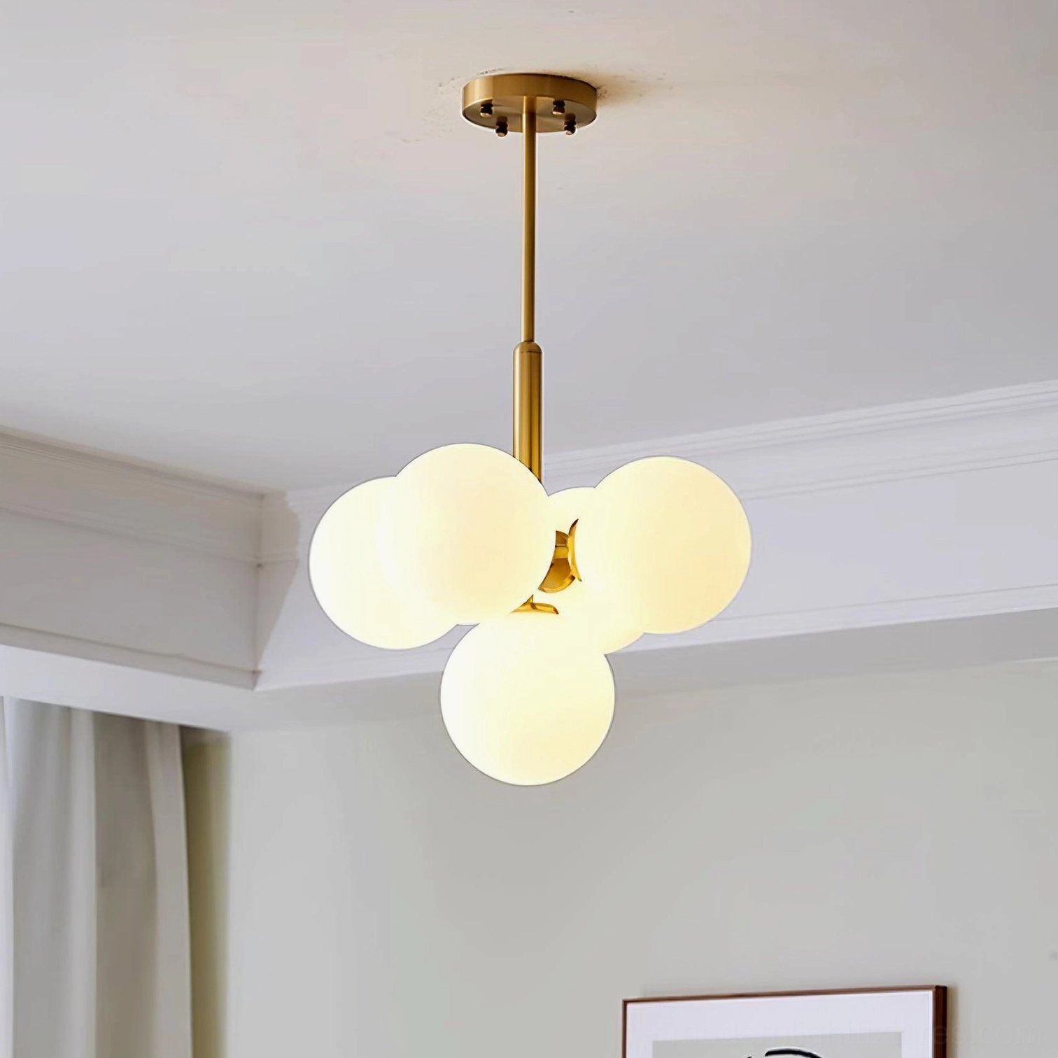 Brass and white glass chandelier in elegant interior space with contemporary furniture