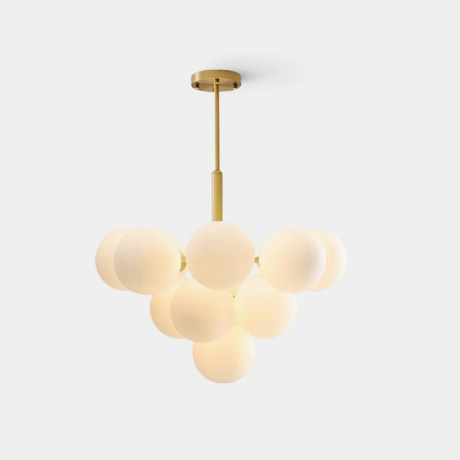 Marais Pointe brass glass globe cluster chandelier studio shot with frosted white spheres on white background