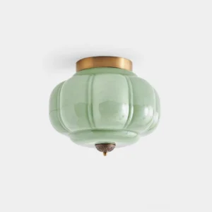 Maravine handcrafted glass ceiling lamp with jade-green glass and brass accents, studio close-up view showing sculptural form and luster finish