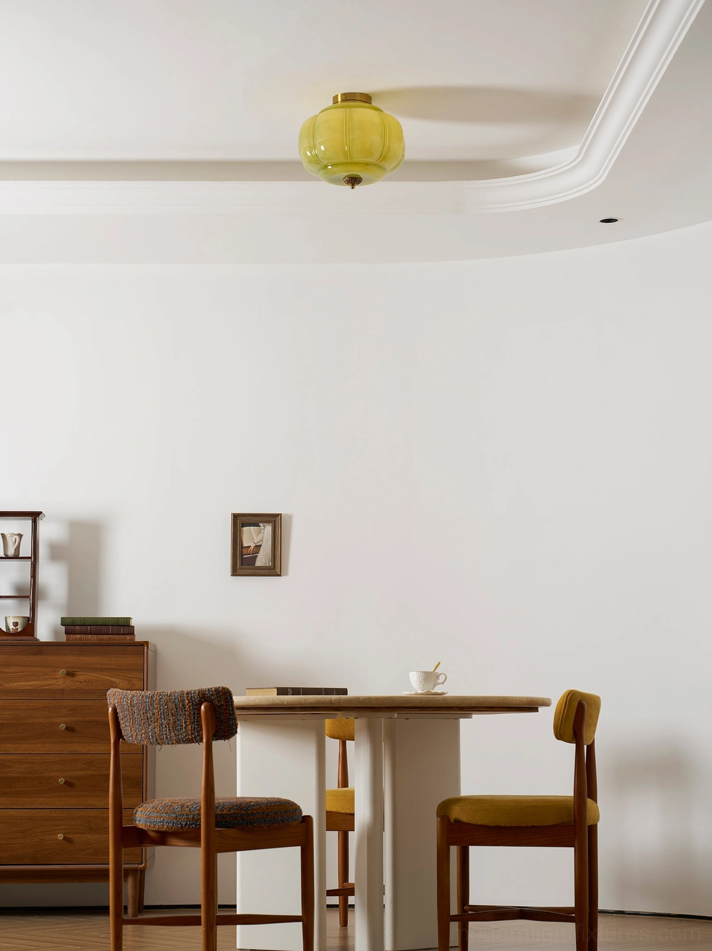 Maravine modern glass ceiling light showing jade-green luster catching daylight in neutral room setting