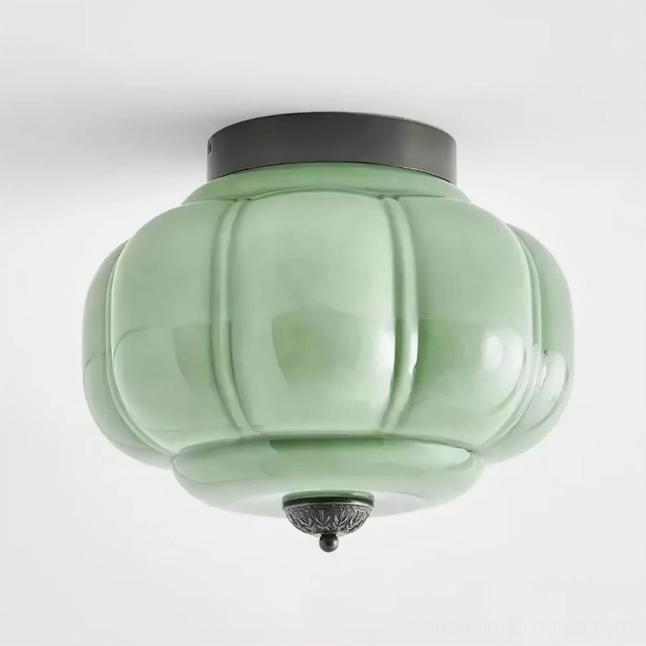 Maravine glass ceiling lamp front view studio photograph, handcrafted jade-green glass with warm brass metal frame