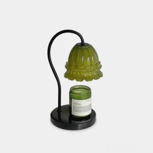 Modern marble candle warmer lamp with floral glass shade and dark marble base, front studio view