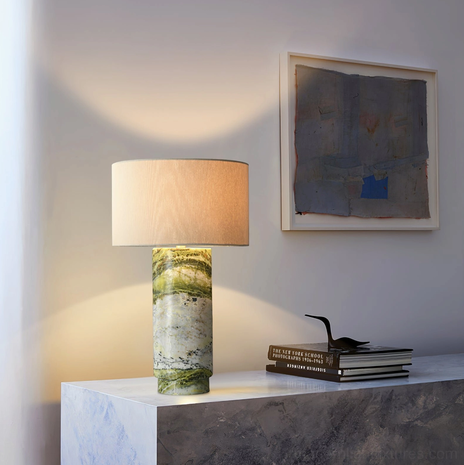 Decorative marble table lamp with beige fabric shade and green veined natural stone base on console table display