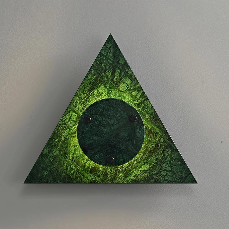 Close-up of green marble geometric wall lamp showing central illuminated disc detail