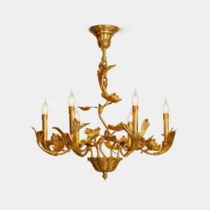 Marcella brass chandelier with ornate botanical detailing featuring 8 candle-style lights and sculpted leaf motifs in polished brass finish - front studio view