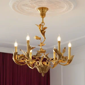 Vintage French-inspired Marcella brass chandelier installed in formal dining room with upward angle view showing intricate metalwork and polished brass candelabra details