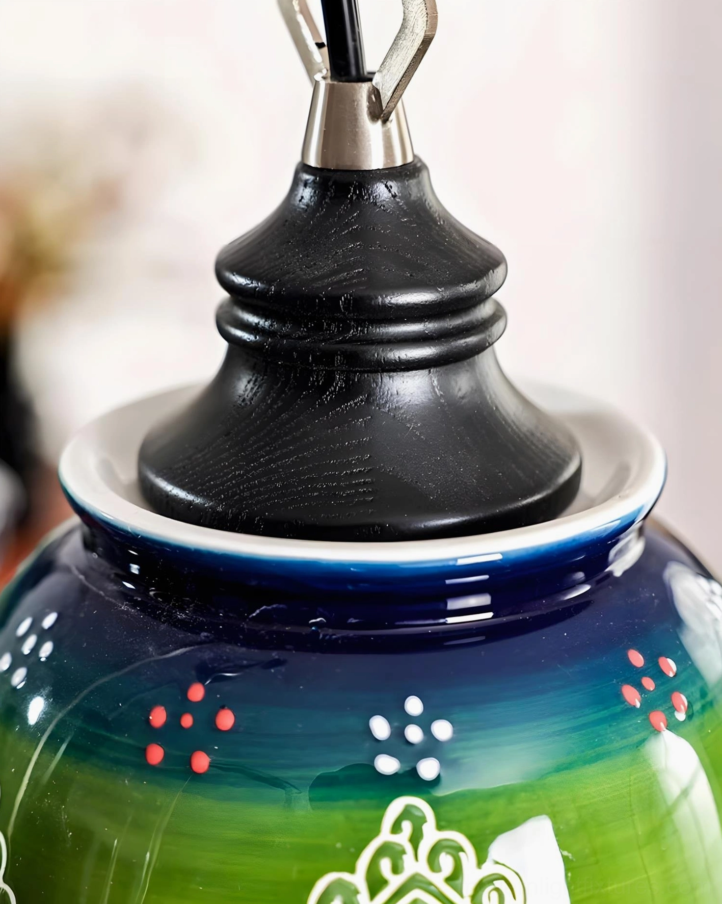 Marcella hand-painted ceramic chandelier detail shot showing green gradient shades with artisanal folk-inspired patterns
