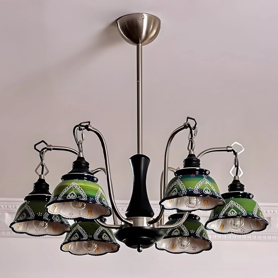 Marcella pendant light showing intricate ornamental detailing on green ceramic shades with dark metal framework architecture