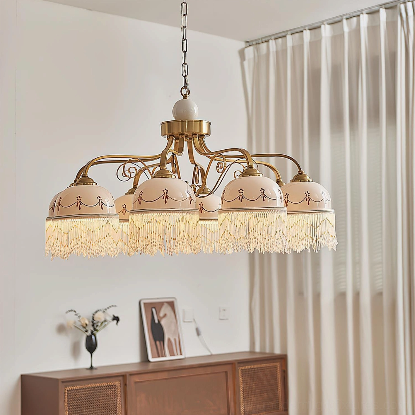 8-head Marcelline vintage chandelier in cozy living room with curtains, illuminated beaded fringe shades creating warm retro ambiance