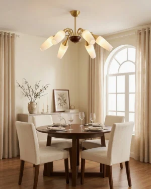 Marcelline 8-light chandelier installed in formal dining room with wooden dining set and arched windows—ceiling view