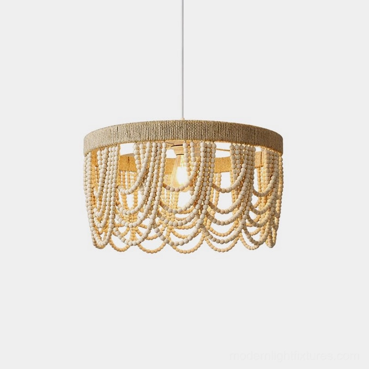 Marela woven drum pendant light with cascading wooden bead fringe, front close-up view showing natural beige texture and handcrafted details