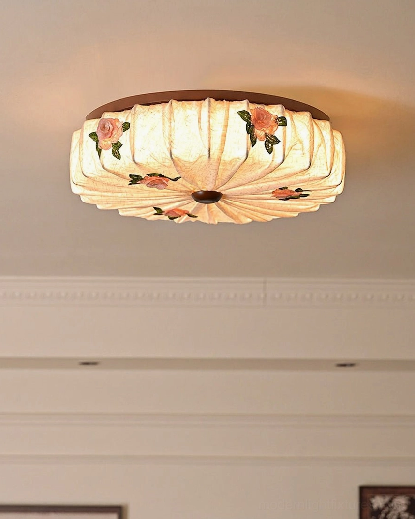 Close-up lit view of Maribelle flush mount showing soft light transmission through pleated fabric and floral pattern detail