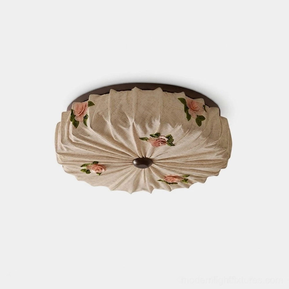Maribelle round pleated fabric flush mount ceiling light with beige linen-look shade and raised rose-flower accents, flat studio overhead view