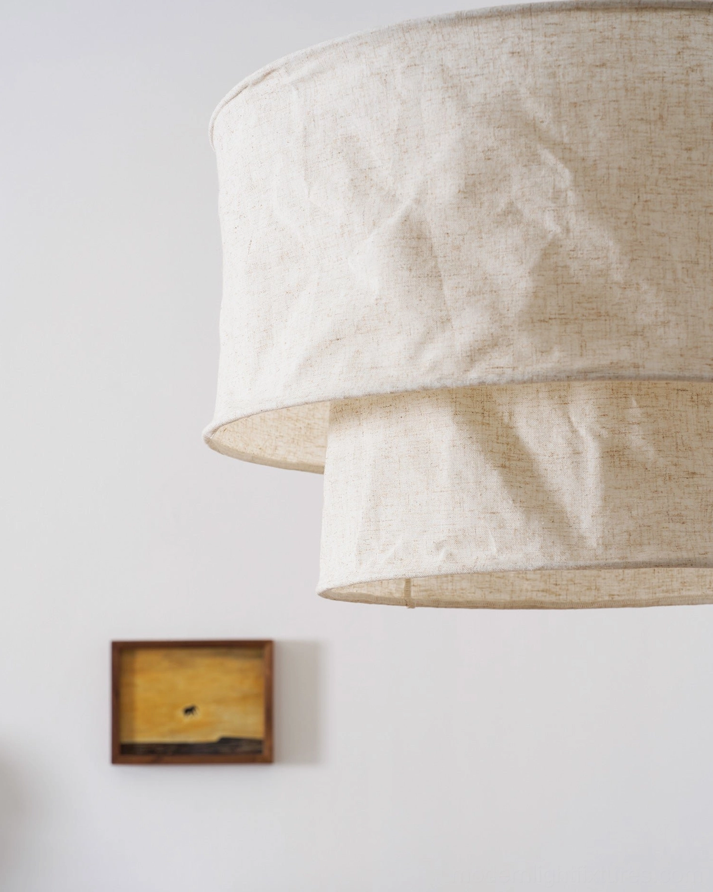 Two-tier textured linen fabric pendant lamp showing crumpled shade and light transmission properties