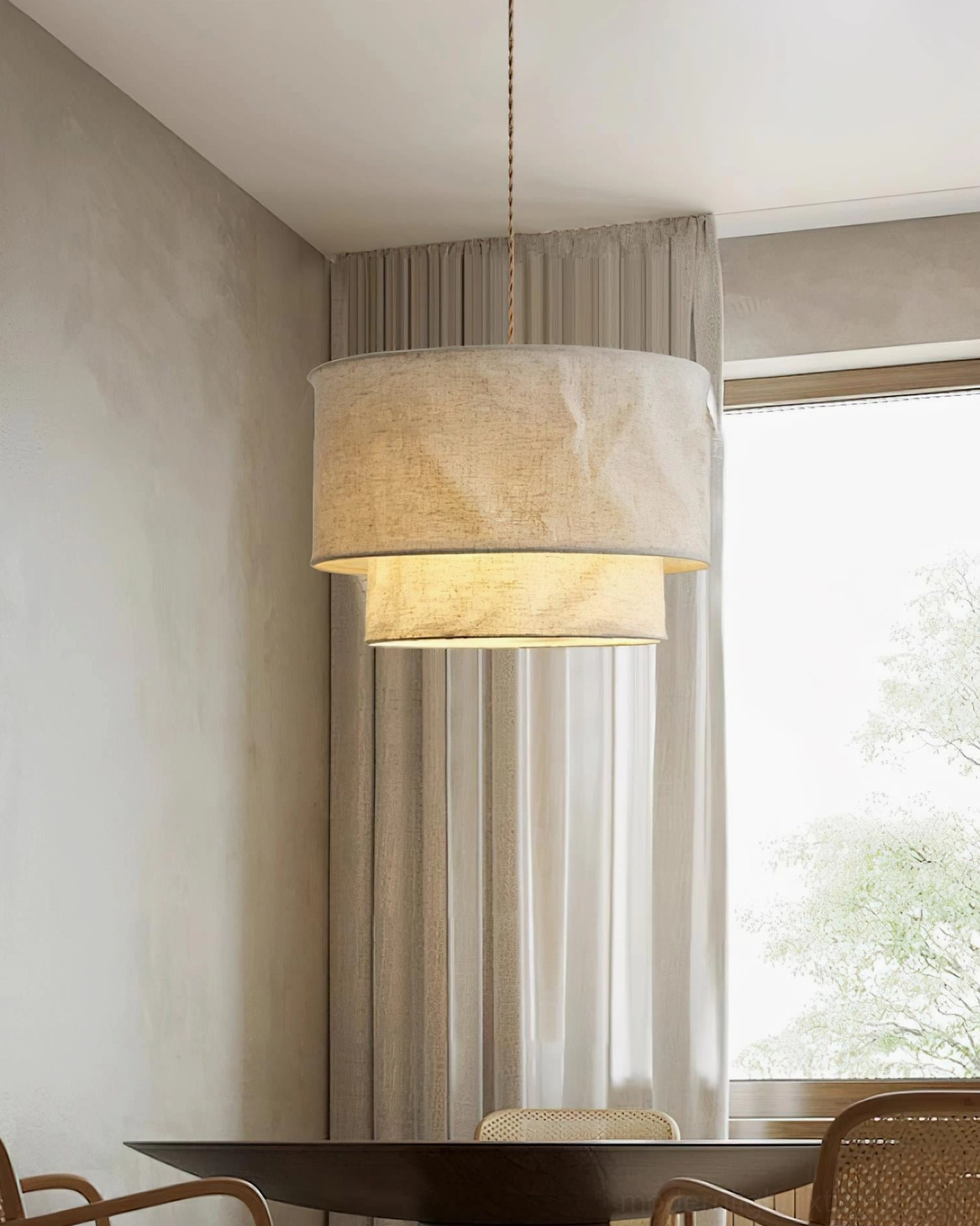Two-tier linen pendant light close-up showing crumpled fabric texture and warm glow characteristics