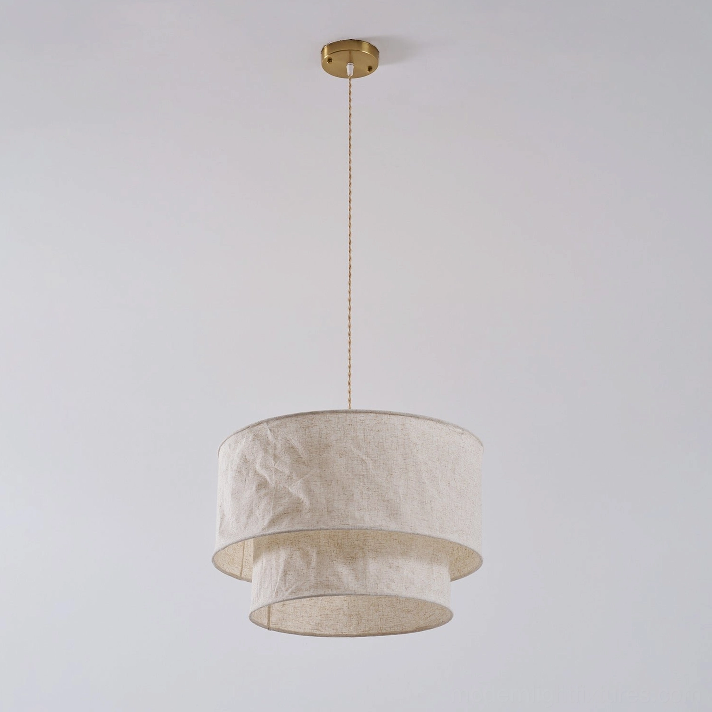 Double-layer linen fabric pendant light in neutral residential interior creating warm ambiance