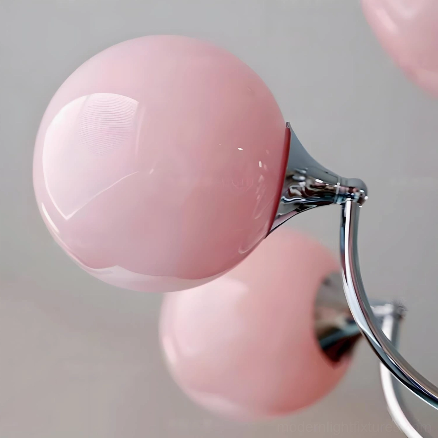 Pink globe Marielle chandelier ambient lighting creating warm inviting glow in residential space