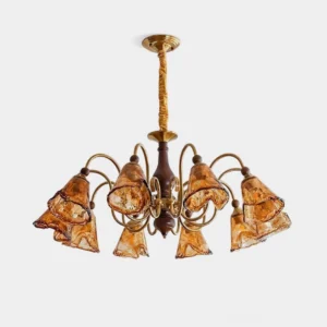 Marigold petal-shaped amber glass chandelier with antique brass frame, frontal studio view showing hand-blown glass shades and curved arms